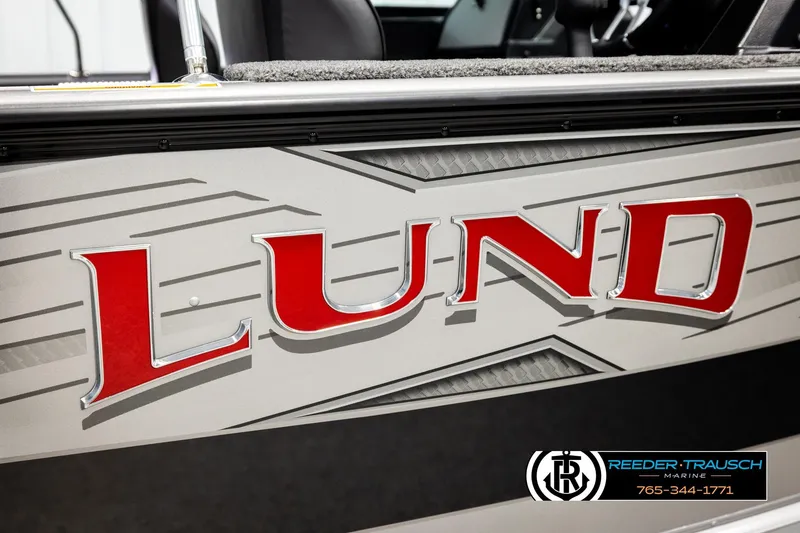 Slide: The Image of 2026 Lund 1875 Impact XS boat with bold red logo and sleek design. - 55