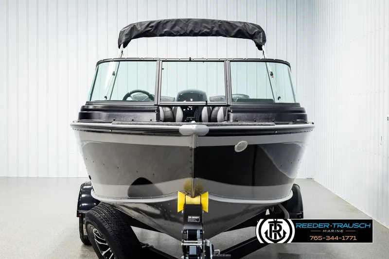 Slide: The Image of 2026 Lund 1875 Impact XS boat in showroom, front view with trailer. - 7