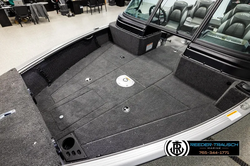 Slide: The Image of 2026 Lund 1875 Impact XS boat interior with spacious carpeted deck and seating. - 9