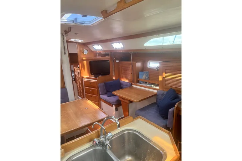 Slide: The Image of Interior of 1995 Catalina 36 MkII sailboat with cozy seating and wooden finishes. - 11