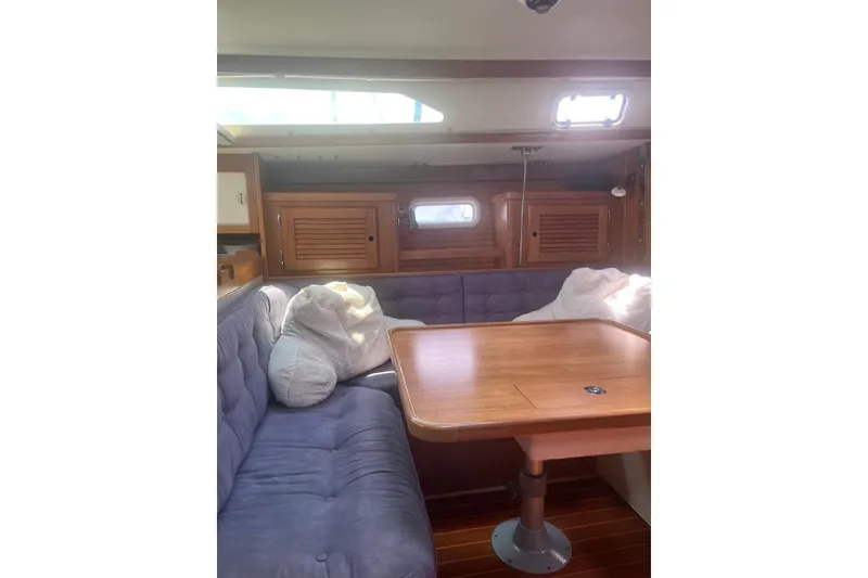 Slide: The Image of Interior of 1995 Catalina 36 MkII sailboat with cozy seating and wooden table. - 13