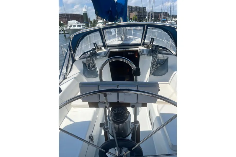 Slide: The Image of Cockpit view of a 1995 Catalina 36 MkII sailboat, featuring steering wheel and navigation instruments. - 8