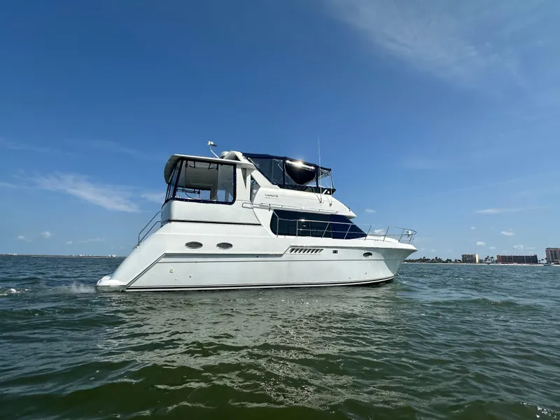 The Image of 2000 Carver 406 Motor Yacht on open water under clear blue sky. - 0