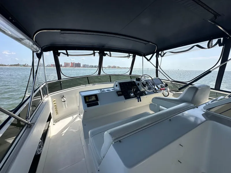 Slide: The Image of Interior view of 2000 Carver 406 Motor Yacht helm station on the water. - 12