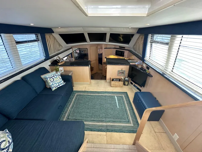 Slide: The Image of Interior of 2000 Carver 406 Motor Yacht with blue sofa and modern kitchen. - 15