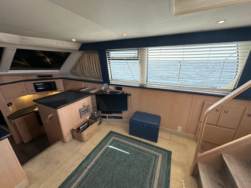 Slide: The Image of Interior of 2000 Carver 406 Motor Yacht with kitchen and seating area. - 17