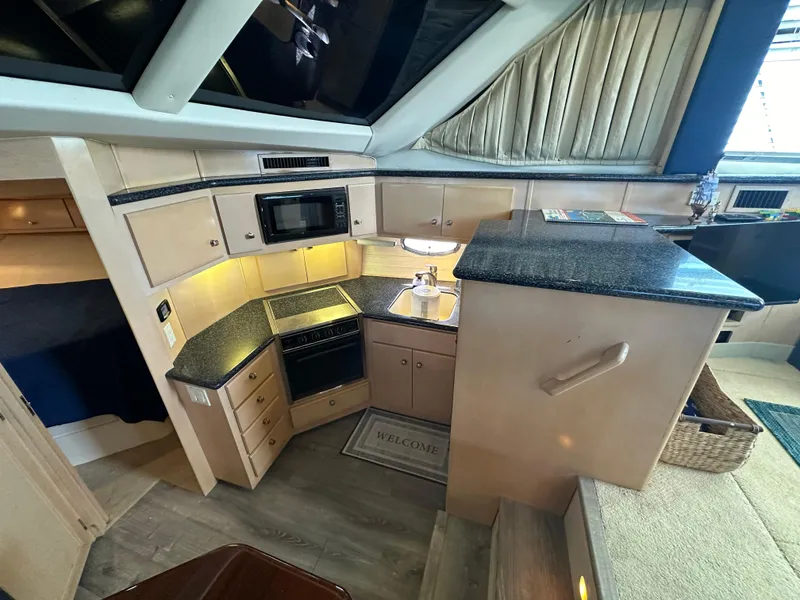 Slide: The Image of 2000 Carver 406 Motor Yacht kitchen with modern appliances and granite countertops. - 19