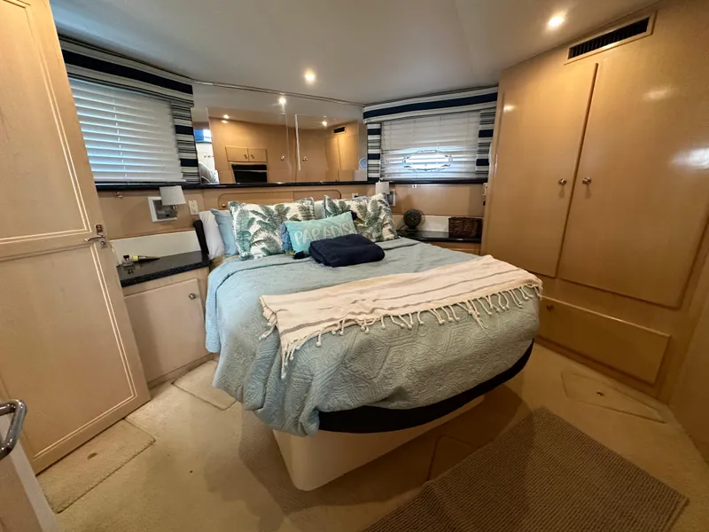 Slide: The Image of Luxurious bedroom interior of a 2000 Carver 406 Motor Yacht with cozy bedding and ample storage. - 26