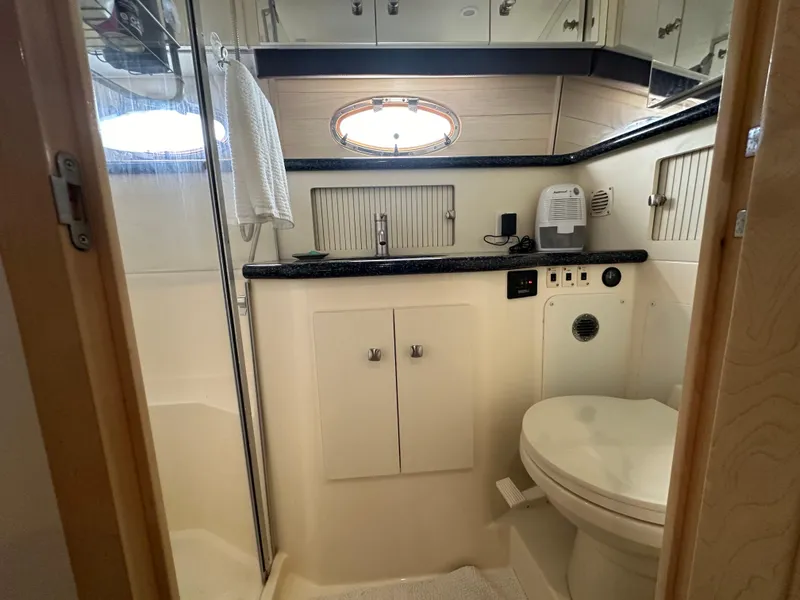 Slide: The Image of Bathroom in 2000 Carver 406 Motor Yacht with shower, toilet, and sink. - 28