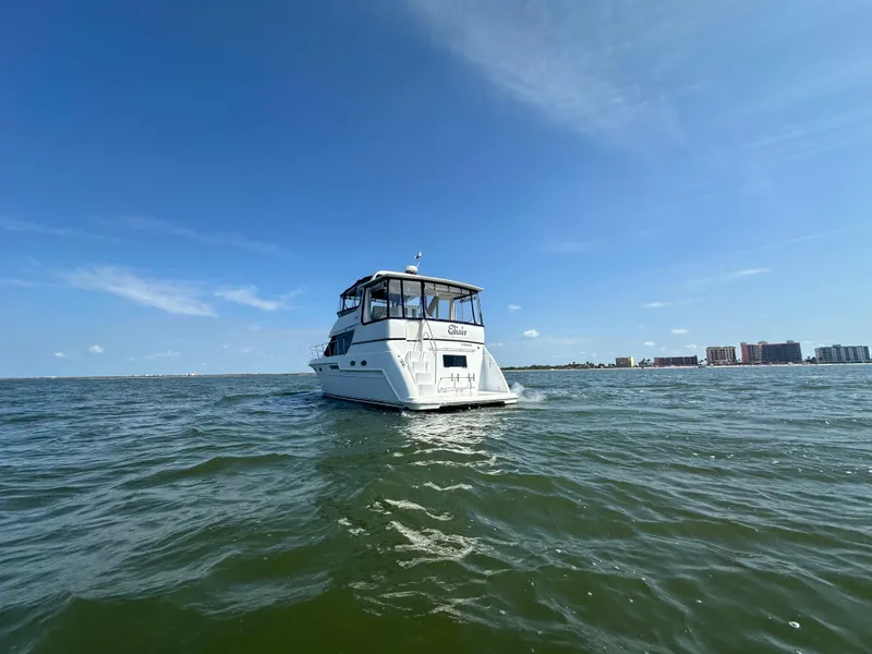 Slide: The Image of 2000 Carver 406 Motor Yacht on open water under clear blue sky. - 3