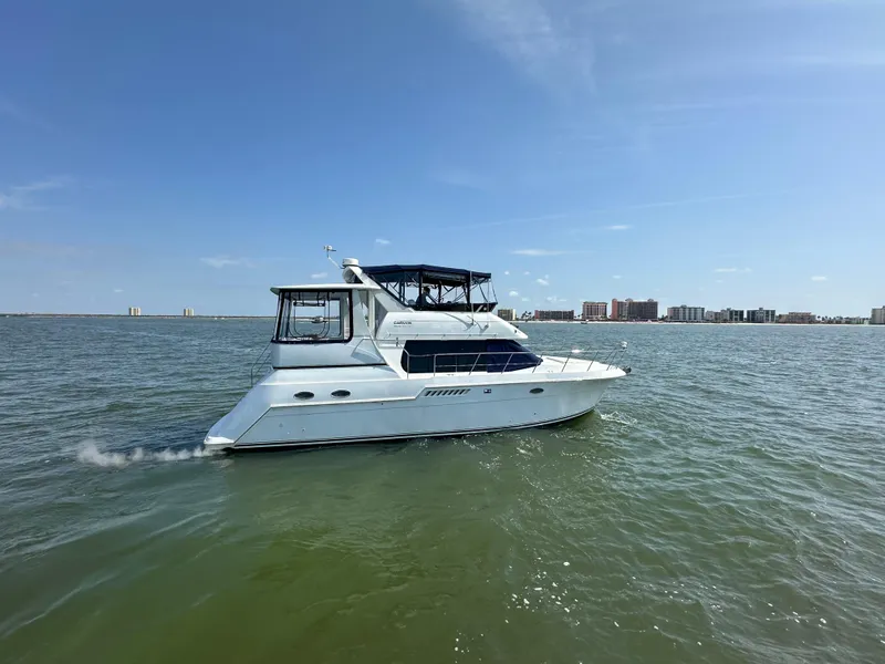 Slide: The Image of 2000 Carver 406 Motor Yacht cruising on open water. - 4