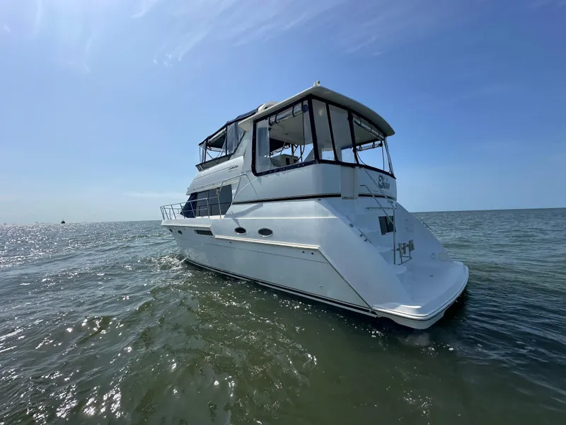 Slide: The Image of 2000 Carver 406 Motor Yacht on open water. - 7