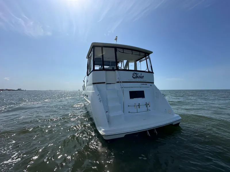 Slide: The Image of 2000 Carver 406 Motor Yacht on open water under clear sky. - 8