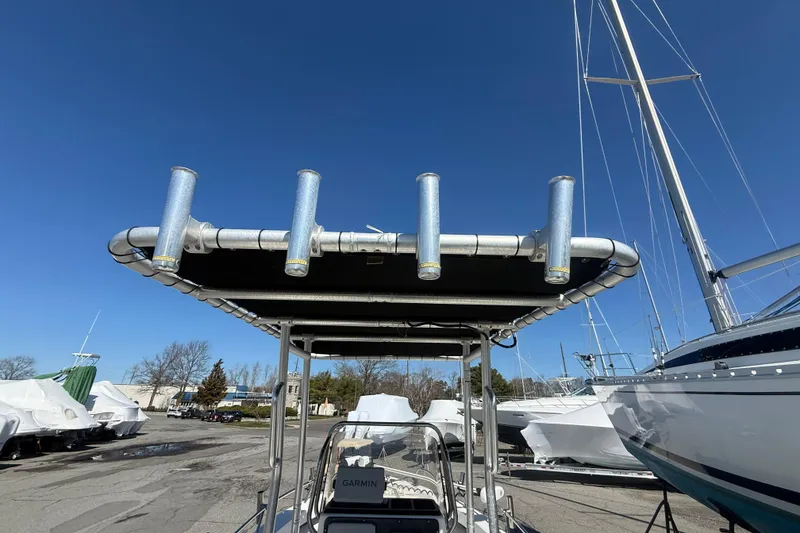 Slide: The Image of 2012 May-Craft 190CC boat with T-top and rod holders under clear blue sky. - 10