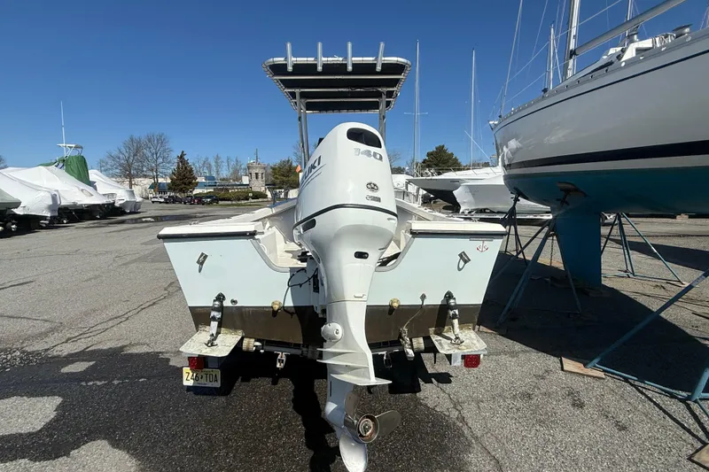 Slide: The Image of 2012 May-Craft 190CC boat with Suzuki outboard motor in a marina setting. - 2