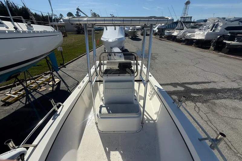 Slide: The Image of 2012 May-Craft 190CC boat with center console, docked among other vessels. - 3