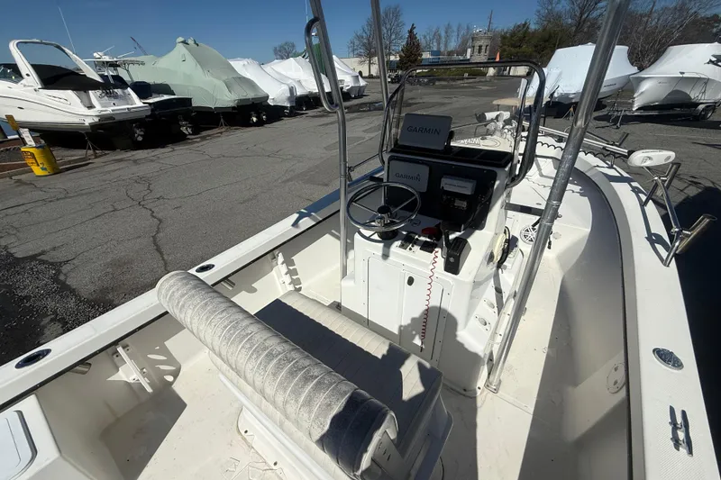 Slide: The Image of 2012 May-Craft 190CC boat interior with Garmin navigation system, docked among covered boats. - 8