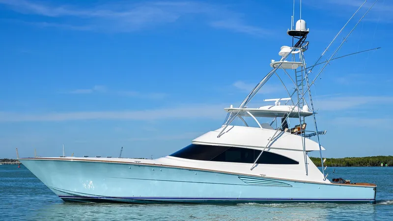 The Image of 2020 Viking 72 Convertible yacht on calm water under clear blue sky. - 0