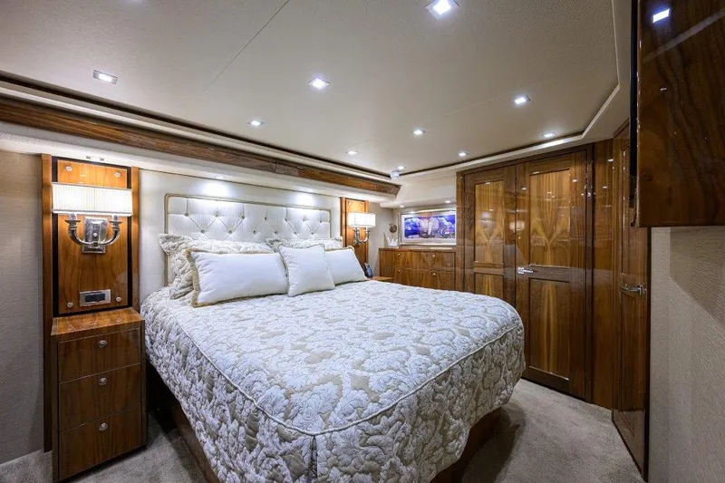 Slide: The Image of Luxurious bedroom interior of 2020 Viking 72 Convertible yacht with elegant wood finishes. - 12