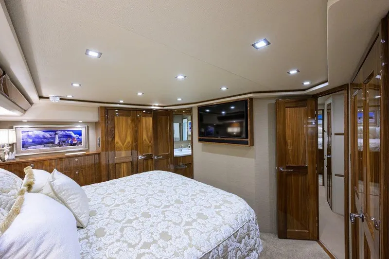 Slide: The Image of Luxurious bedroom interior of 2020 Viking 72 Convertible yacht with elegant wood finishes. - 13