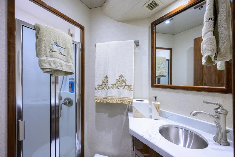 Slide: The Image of Luxurious bathroom in 2020 Viking 72 Convertible yacht with modern fixtures and elegant decor. - 19
