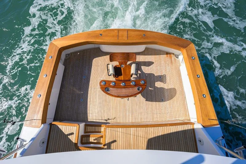 Slide: The Image of Aerial view of 2020 Viking 72 Convertible yacht's teak deck and fishing chair. - 27
