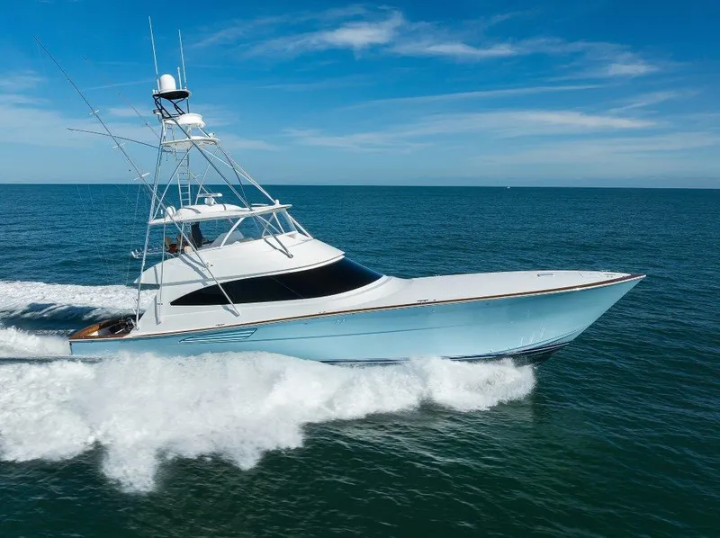 Slide: The Image of 2020 Viking 72 Convertible yacht cruising on open sea under clear blue sky. - 44