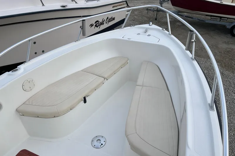 Slide: The Image of 2011 Mako 212 Center Console boat with cushioned seating and stainless steel railings. - 4