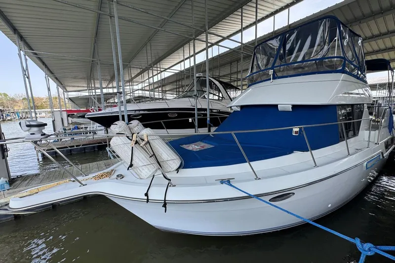 Slide: The Image of 1993 Carver 300 Aft Cabin yacht docked under covered marina. - 1
