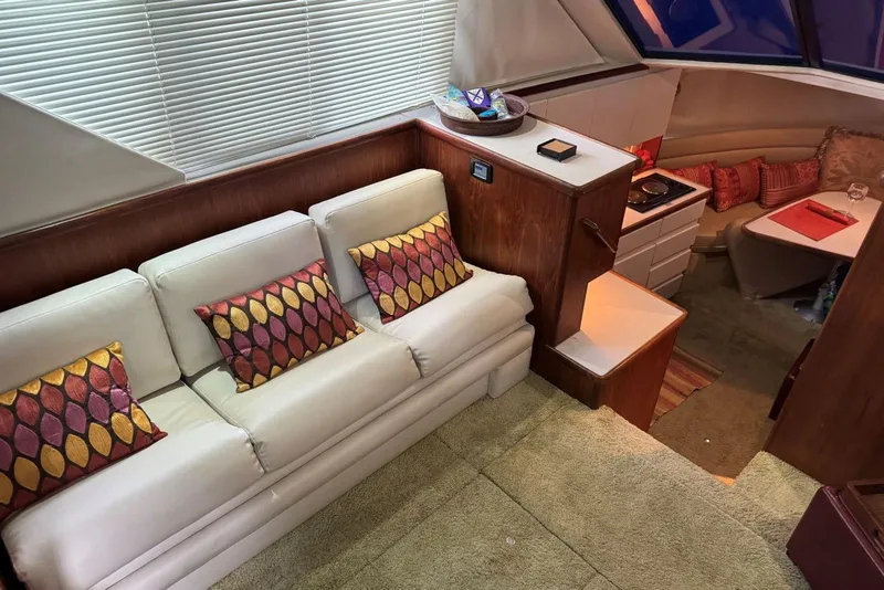 Slide: The Image of Interior of 1993 Carver 300 Aft Cabin with cozy seating and dining area. - 17