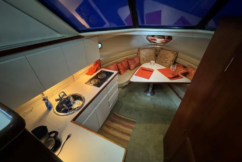 Slide: The Image of Interior of 1993 Carver 300 Aft Cabin with kitchenette and cozy dining area. - 18