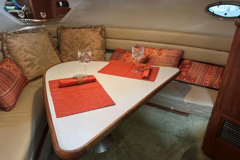 Slide: The Image of Interior of 1993 Carver 300 Aft Cabin with cozy dining area and decorative cushions. - 20