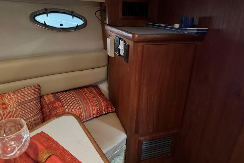 Slide: The Image of Interior of 1993 Carver 300 Aft Cabin with cozy seating and decorative pillows. - 21