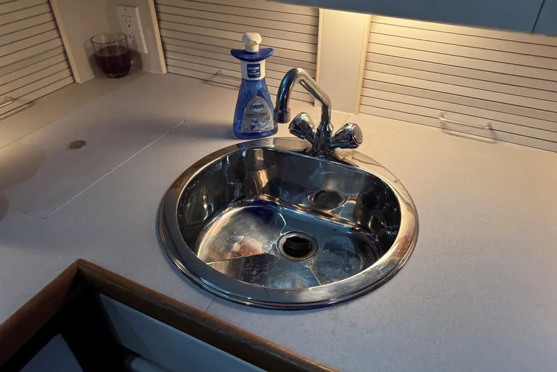 Slide: The Image of Stainless steel sink in 1993 Carver 300 Aft Cabin boat kitchen. - 25