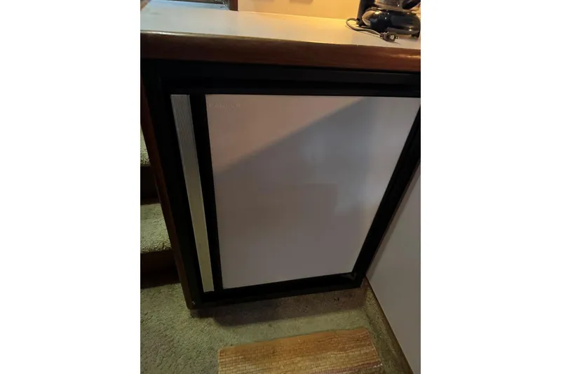 Slide: The Image of 1993 Carver 300 Aft Cabin interior with compact refrigerator. - 26