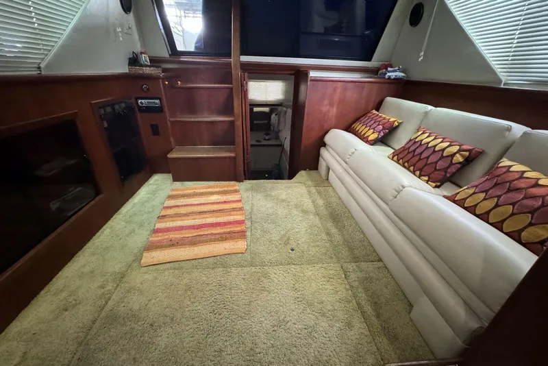 Slide: The Image of Interior of 1993 Carver 300 Aft Cabin with beige sofa and colorful cushions. - 30