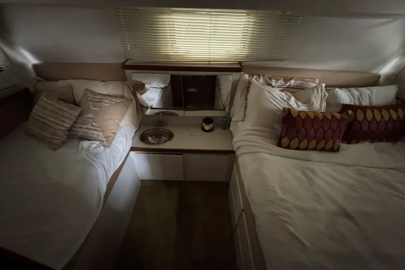 Slide: The Image of Cozy interior of 1993 Carver 300 Aft Cabin with twin beds and pillows. - 32