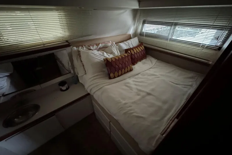 Slide: The Image of Cozy bedroom in 1993 Carver 300 Aft Cabin yacht with bed and window blinds. - 33