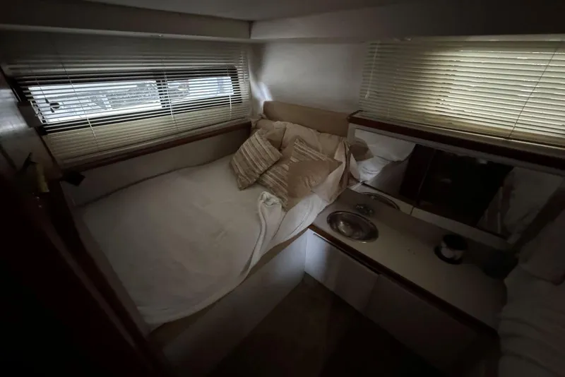 Slide: The Image of Cozy cabin interior of 1993 Carver 300 Aft Cabin with bed and sink. - 34