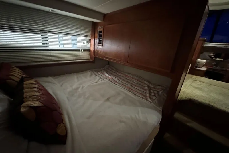 Slide: The Image of Cozy bedroom in 1993 Carver 300 Aft Cabin yacht with wooden accents and soft lighting. - 35