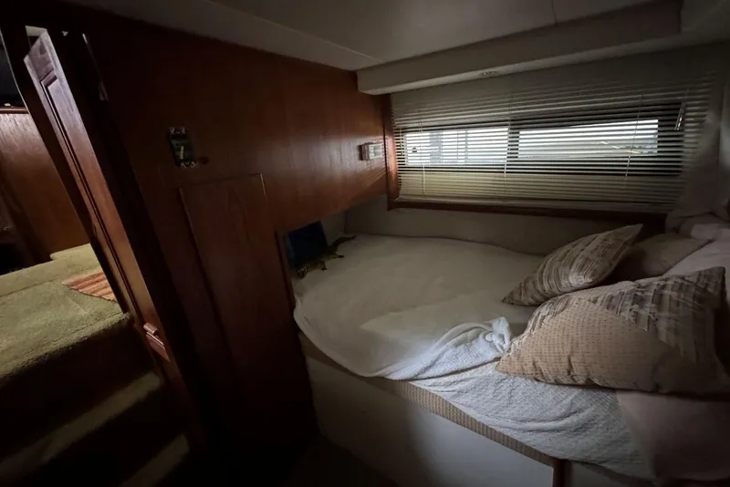 Slide: The Image of Cozy cabin interior of 1993 Carver 300 Aft Cabin with bed and window blinds. - 36