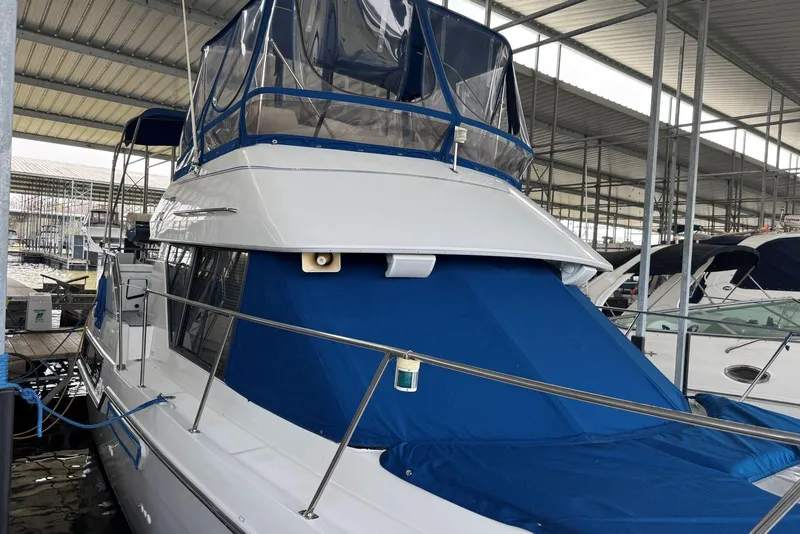 Slide: The Image of 1993 Carver 300 Aft Cabin yacht docked in a covered marina. - 4