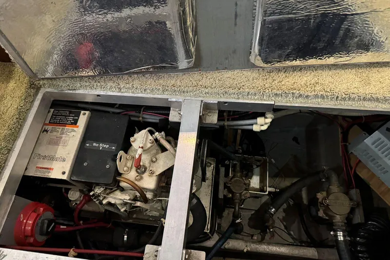 Slide: The Image of Engine compartment of a 1993 Carver 300 Aft Cabin boat, showing mechanical components. - 42