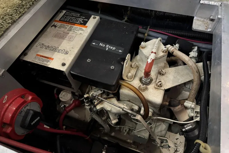 Slide: The Image of Engine compartment of a 1993 Carver 300 Aft Cabin boat, featuring mechanical components. - 43