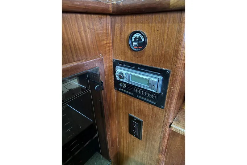 Slide: The Image of 1993 Carver 300 Aft Cabin interior with wood paneling and control panel. - 44
