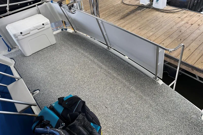 Slide: The Image of 1993 Carver 300 Aft Cabin boat deck with cooler and bags, docked at marina. - 9