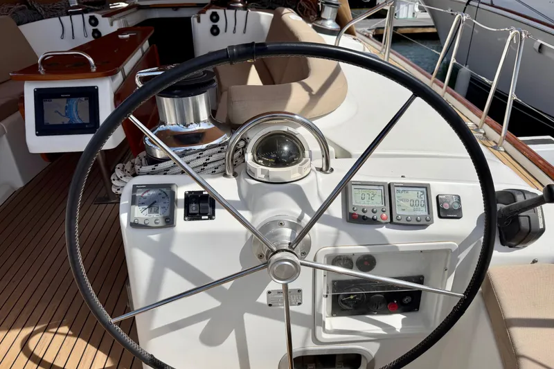 Slide: The Image of Steering wheel and navigation instruments on a 2006 Beneteau Oceanis 523 sailboat. - 11