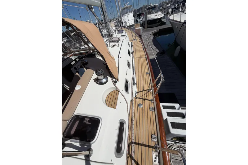 Slide: The Image of 2006 Beneteau Oceanis 523 sailboat deck with teak finish, docked at marina. - 12