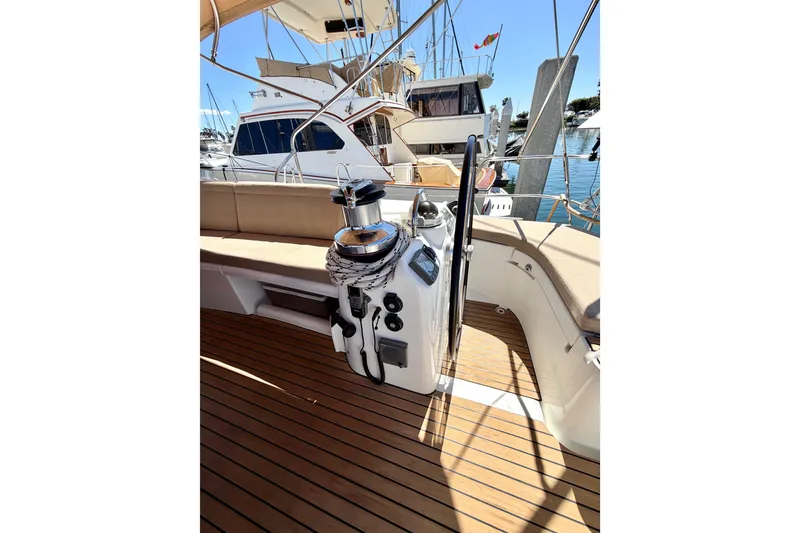Slide: The Image of Cockpit of 2006 Beneteau Oceanis 523 sailboat with teak flooring and steering wheel. - 13