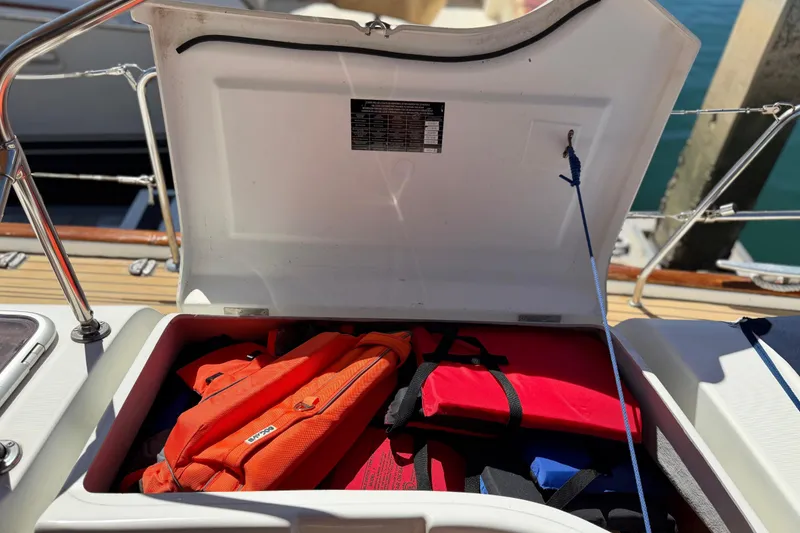 Slide: The Image of Open storage compartment on 2006 Beneteau Oceanis 523 sailboat with life jackets inside. - 15